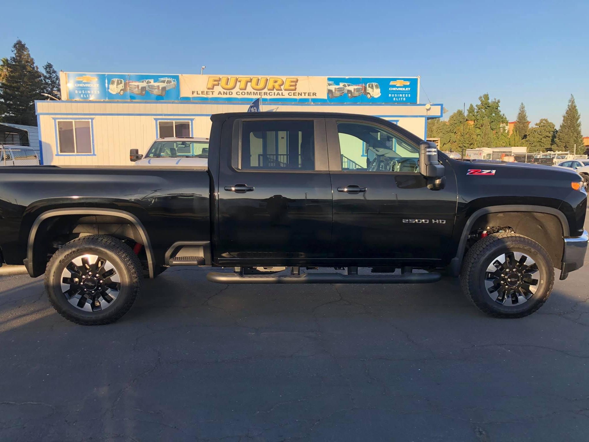 Side view of a dark blue Chevy Silverado 2500HD crew cab with long bed Z71 LT