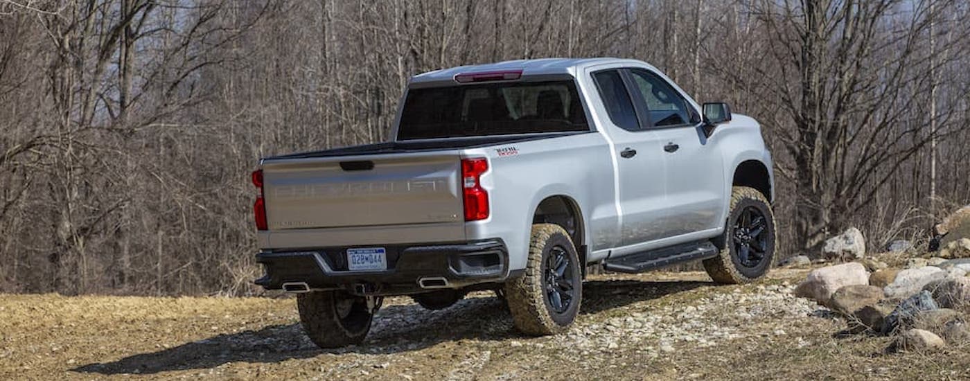 A grey 2020 Chevy Silverado 1500 Trail Boss is shown from the rear at an angle.