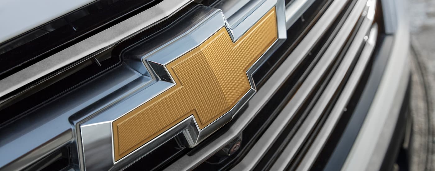 A close up shows the Chevy badge on a 2022 Chevy Traverse Premium.