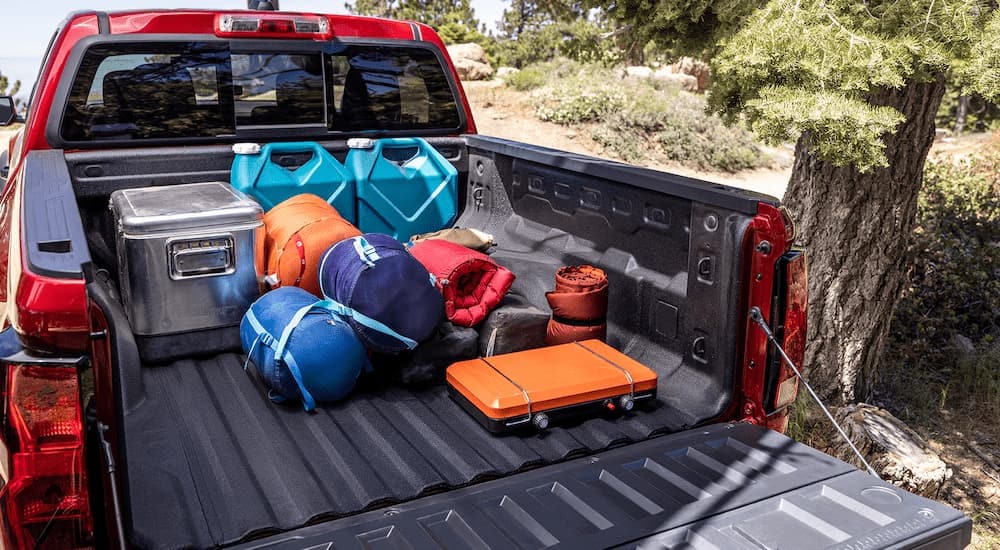 A bunch of cargo in the bed of a red 2025 Chevy Colorado.