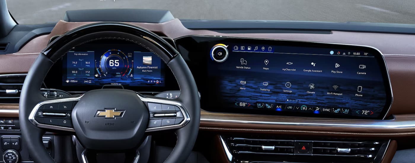 The steering wheel and infotainment screen in a 2025 Chevy Suburban High Country.