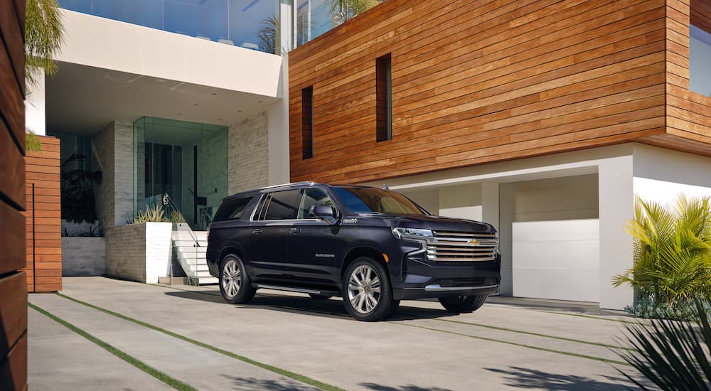 A grey 2022 Chevy Suburban High Country is shown from the front at an angle.