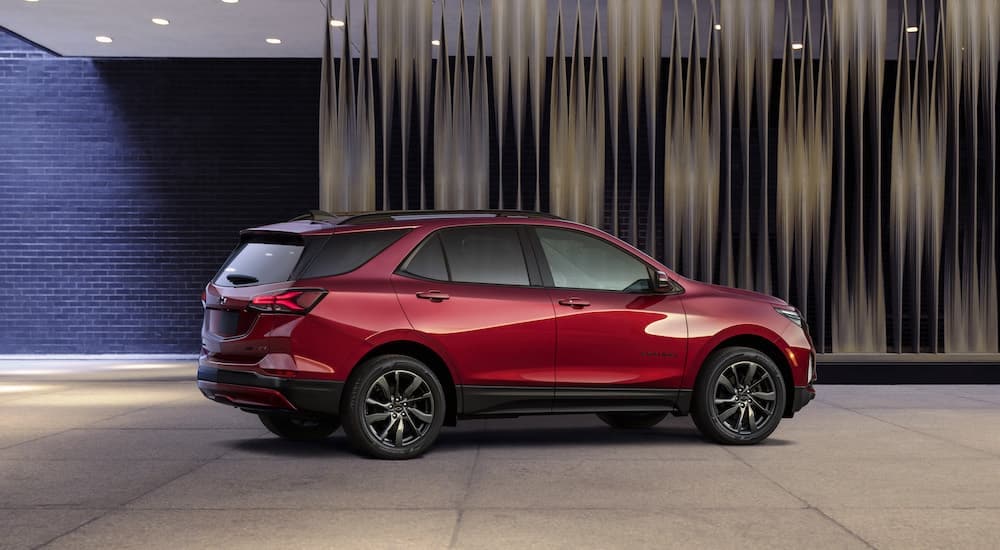 A red 2022 Chevy Equinox RS is shown from the side while parked.
