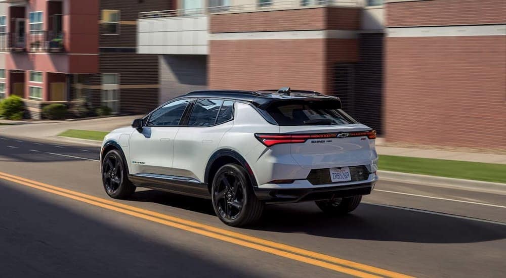 Chevy%20dealer%20near%20Woodland%20-%202025%20Chevy%20Equinox%20EV%20RS%20-%20White.jpg A white 2025 Chevy Equinox EV RS is shown driving on a city street.