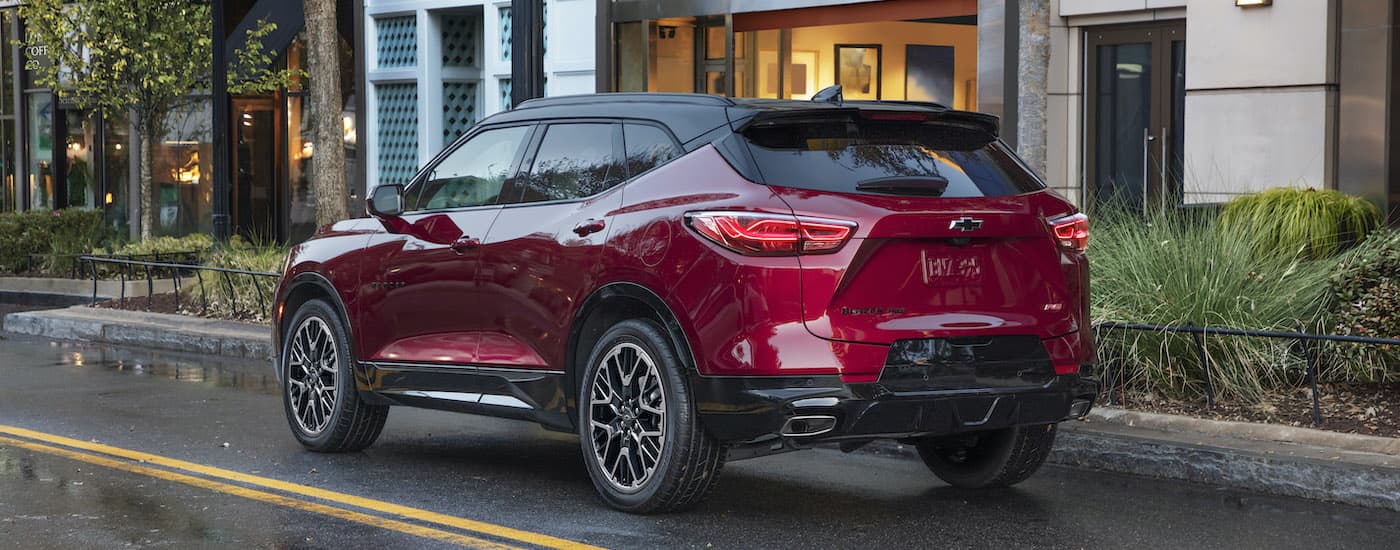Rear view of a red 2023 Chevy Blazer RS parked on a city street.