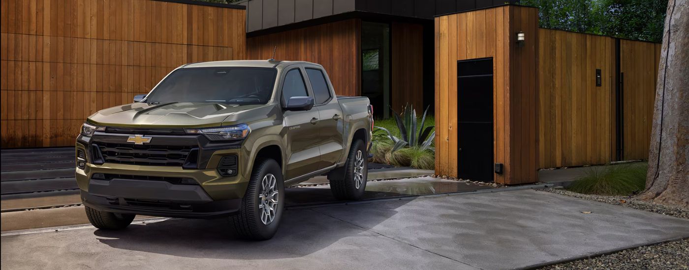 An army green 2025 Chevy Colorado LT parked in a residential driveway.
