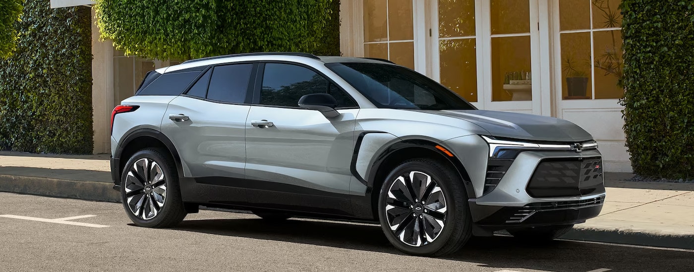 A silver 2024 Chevy Blazer EV RS parked on a city street.