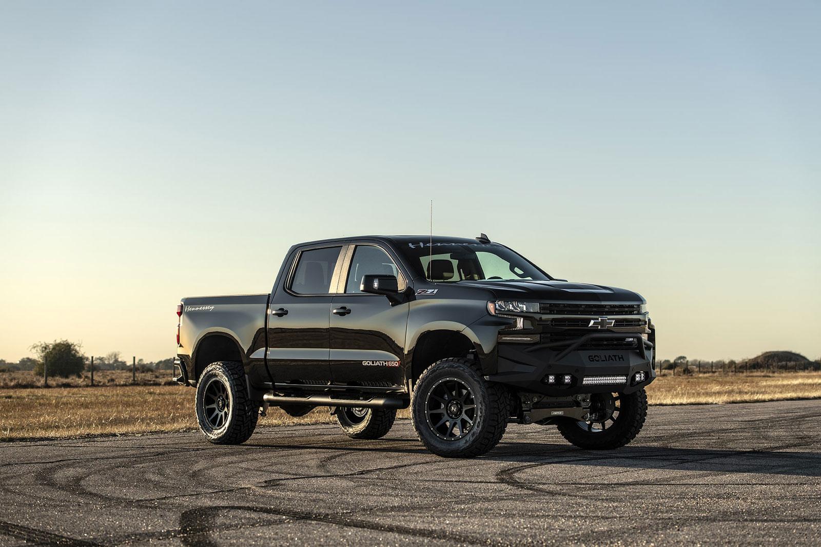 Shiny black Chevy Silverado with Hennessey Goliath  650 Supercharged upgrades, from front right