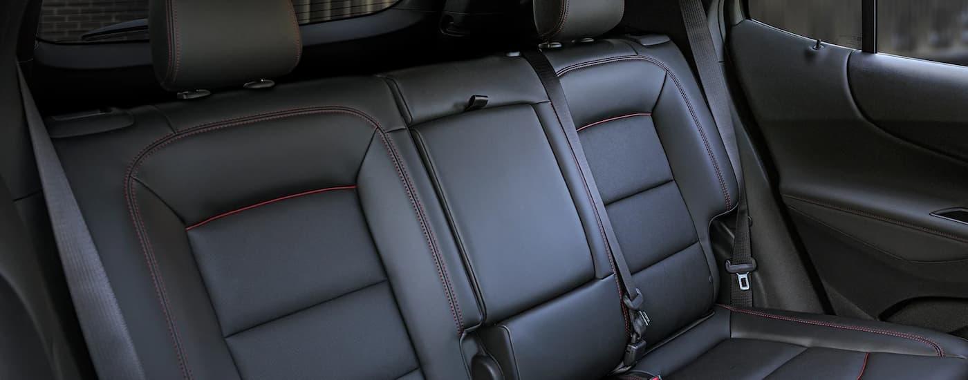 A close up shows the black leather seats in a 2023 Chevy Equinox RS.