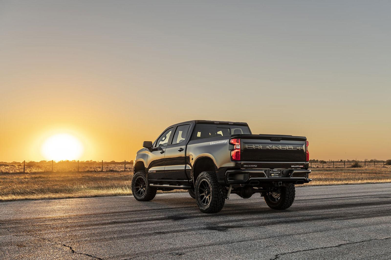 Shiny black Chevy Silverado with Hennessey Goliath  650 Supercharged upgrades, from rear driver's side