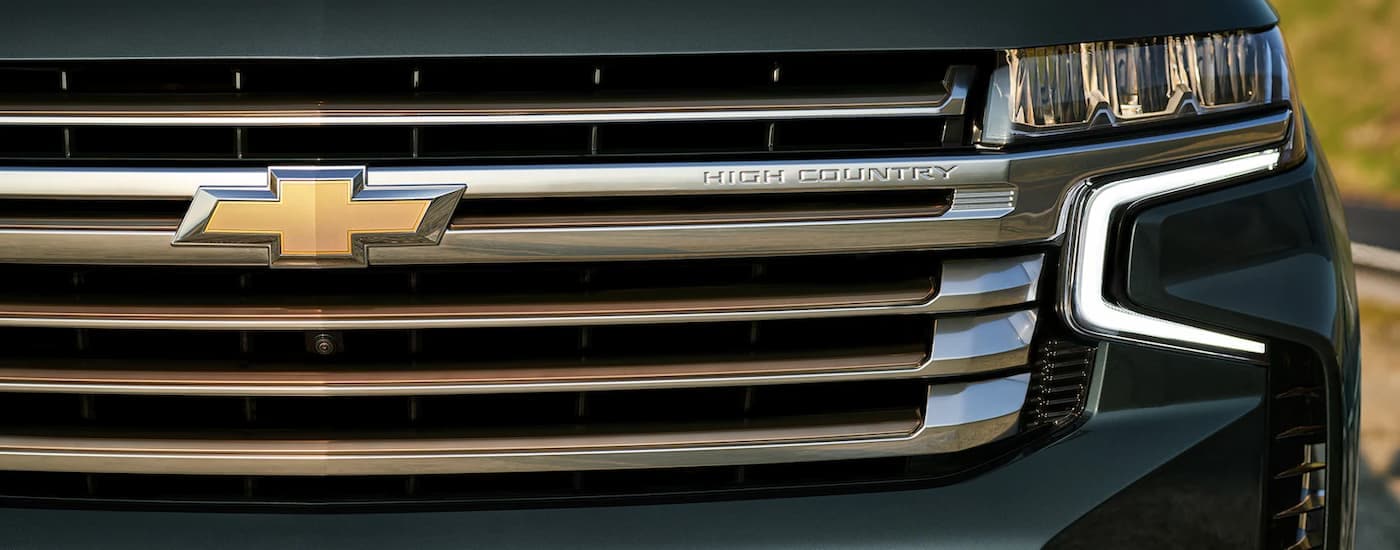 A close up of the grille on a green 2022 Chevy Tahoe High Country is shown.