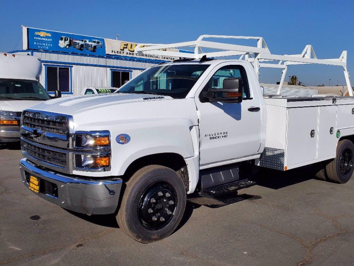 White Chevy Silverado 5500HD with Scelzi Combo body, seen from the side in front of the Future Chevrolet Dealership