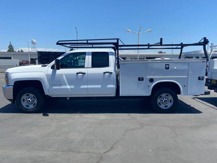 Side view of a white Chevy Silverado 2500HD double cab with Knapheide service body