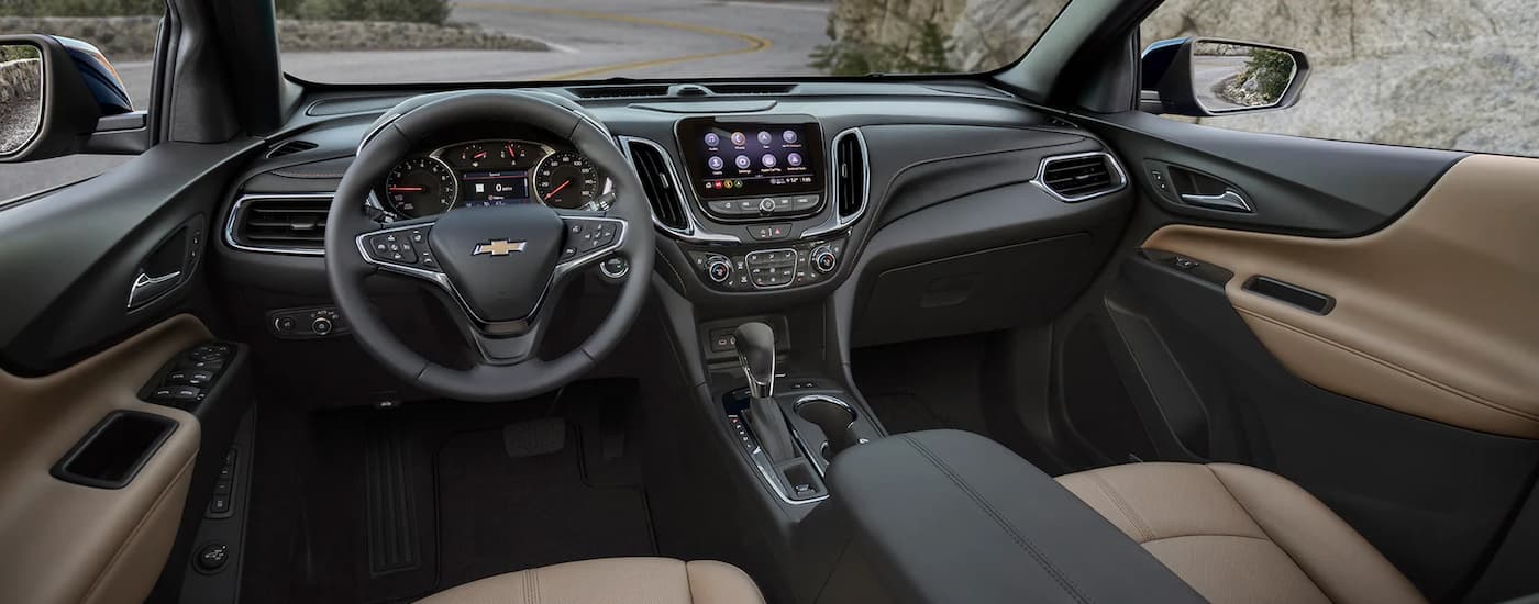 The black and tan interior is shown in a 2023 Chevy Equinox LT.