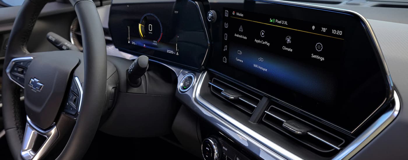 A close up of the steering wheel and dashboard in a 2024 Chevy Trax is shown.