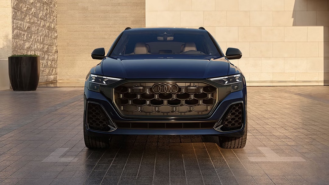 Front view of the Audi SQ8 2025, parked in front of a building with these innovative headlights