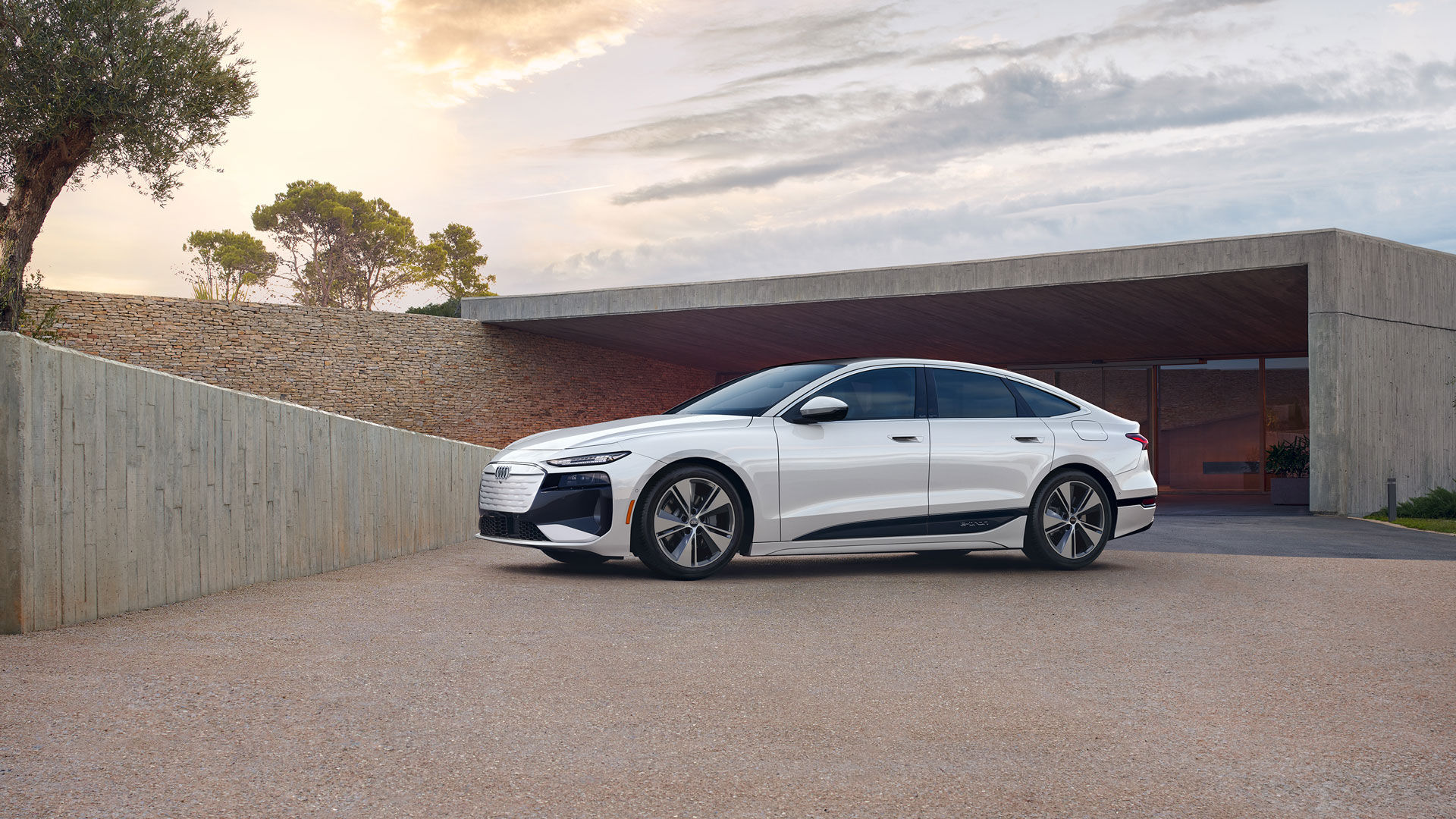 The Audi A6 e-tron 2025 parked in front of a residence.