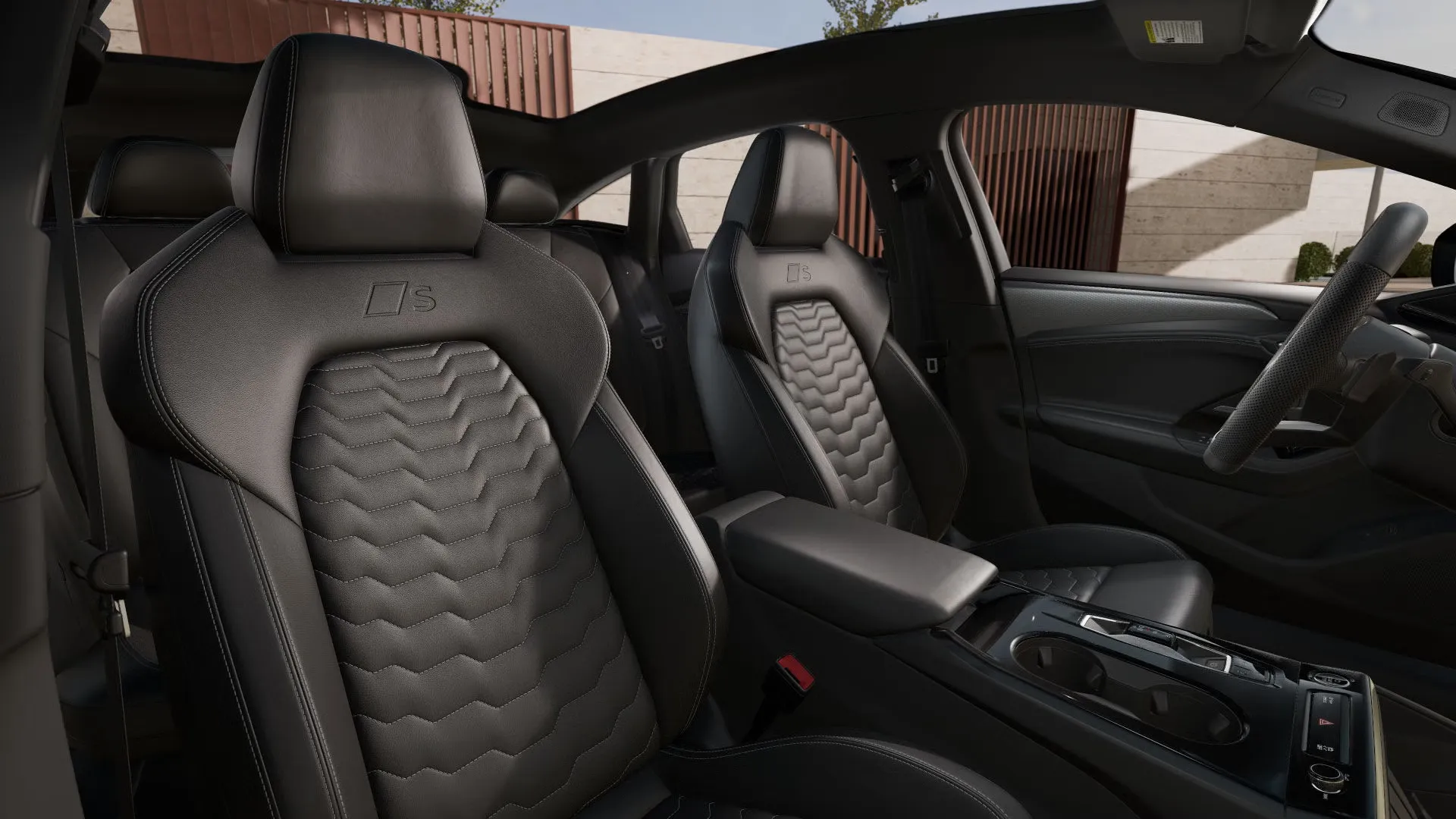 Interior of the 2025 Audi A6 e-tron with black leather sport seats and contrasting stitching.