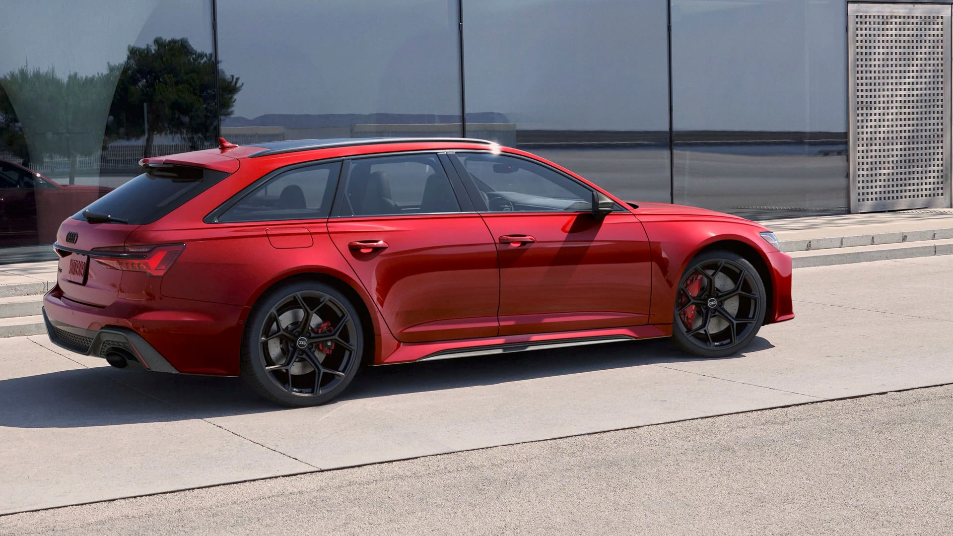 Audi RS 6 2025 parked in front of a building in town.