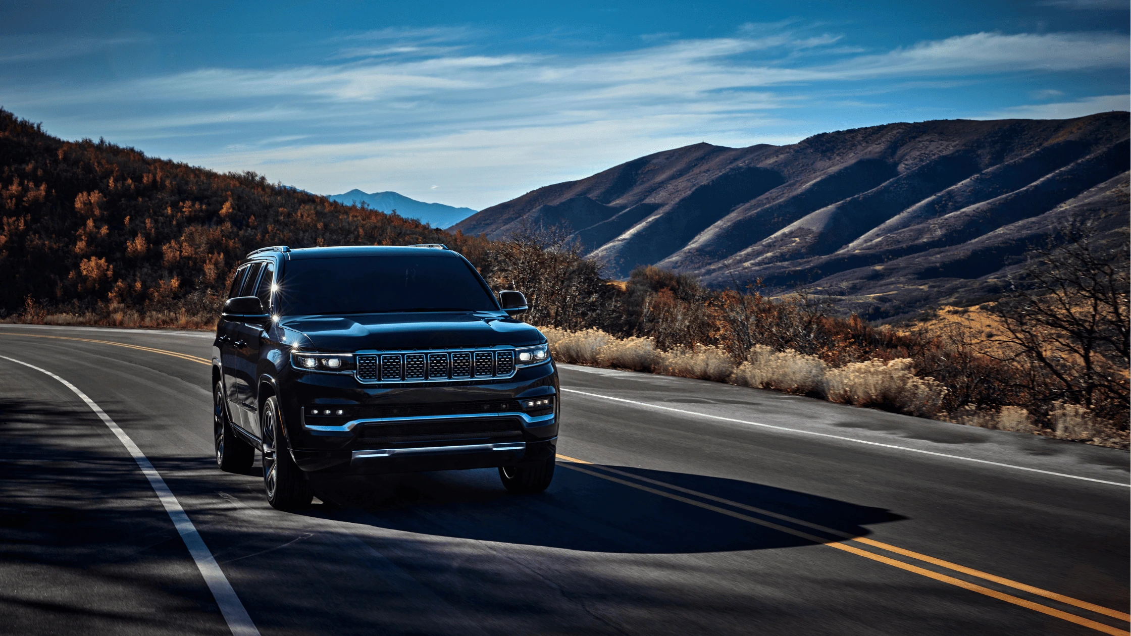 2025 Jeep Grand Wagoneer driving through scenic fall mountains near Fort Myers, Florida