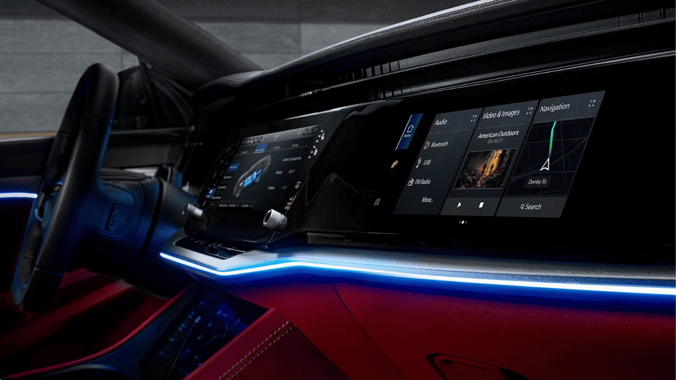 Advanced infotainment system inside a modern vehicle, showcasing a large digital dashboard with multiple displays, blue ambient lighting, and sleek interior styling with red accents.