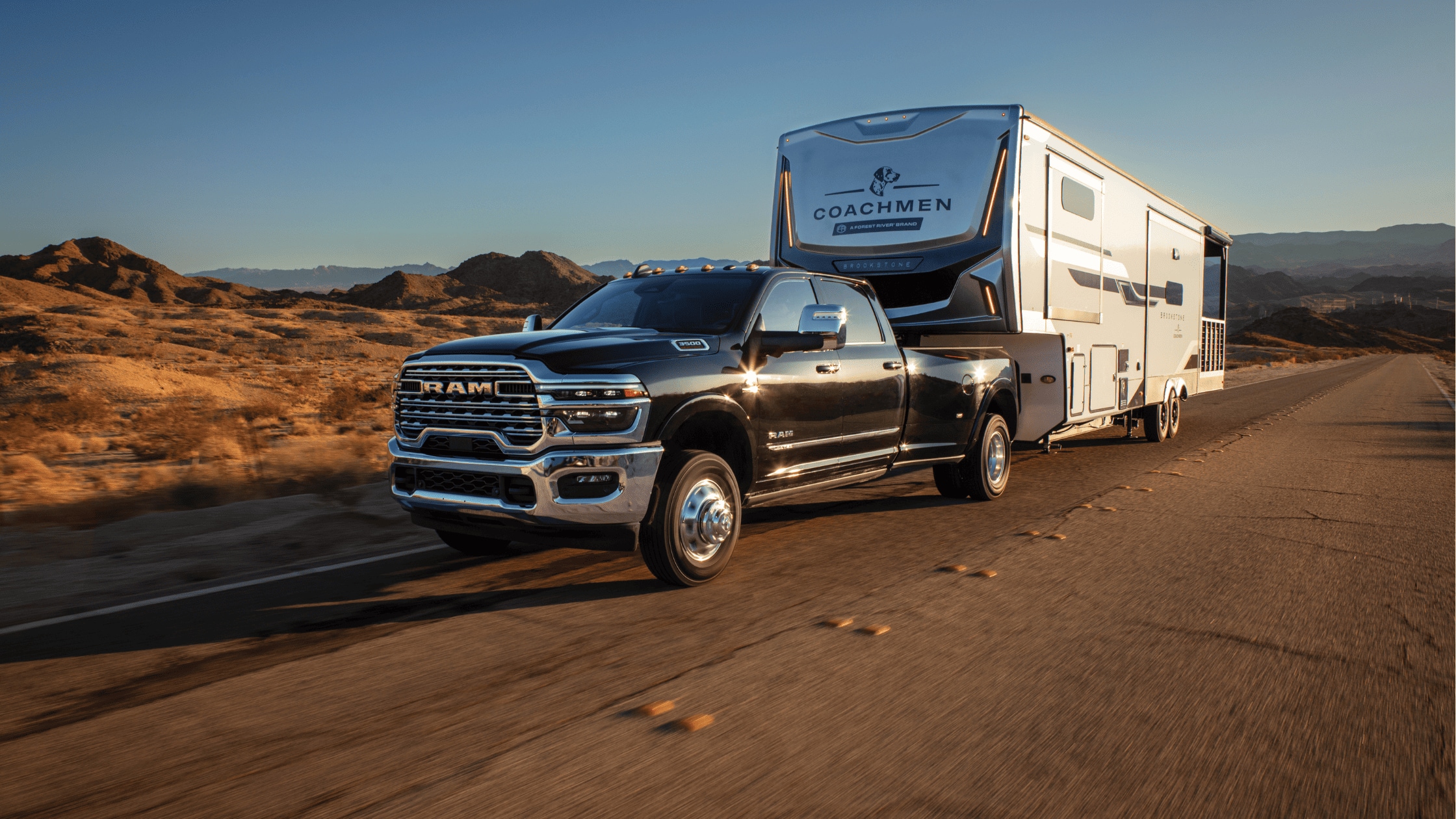 2025 Ram 2500 towing off-road vehicles on desert highway near Fort Myers