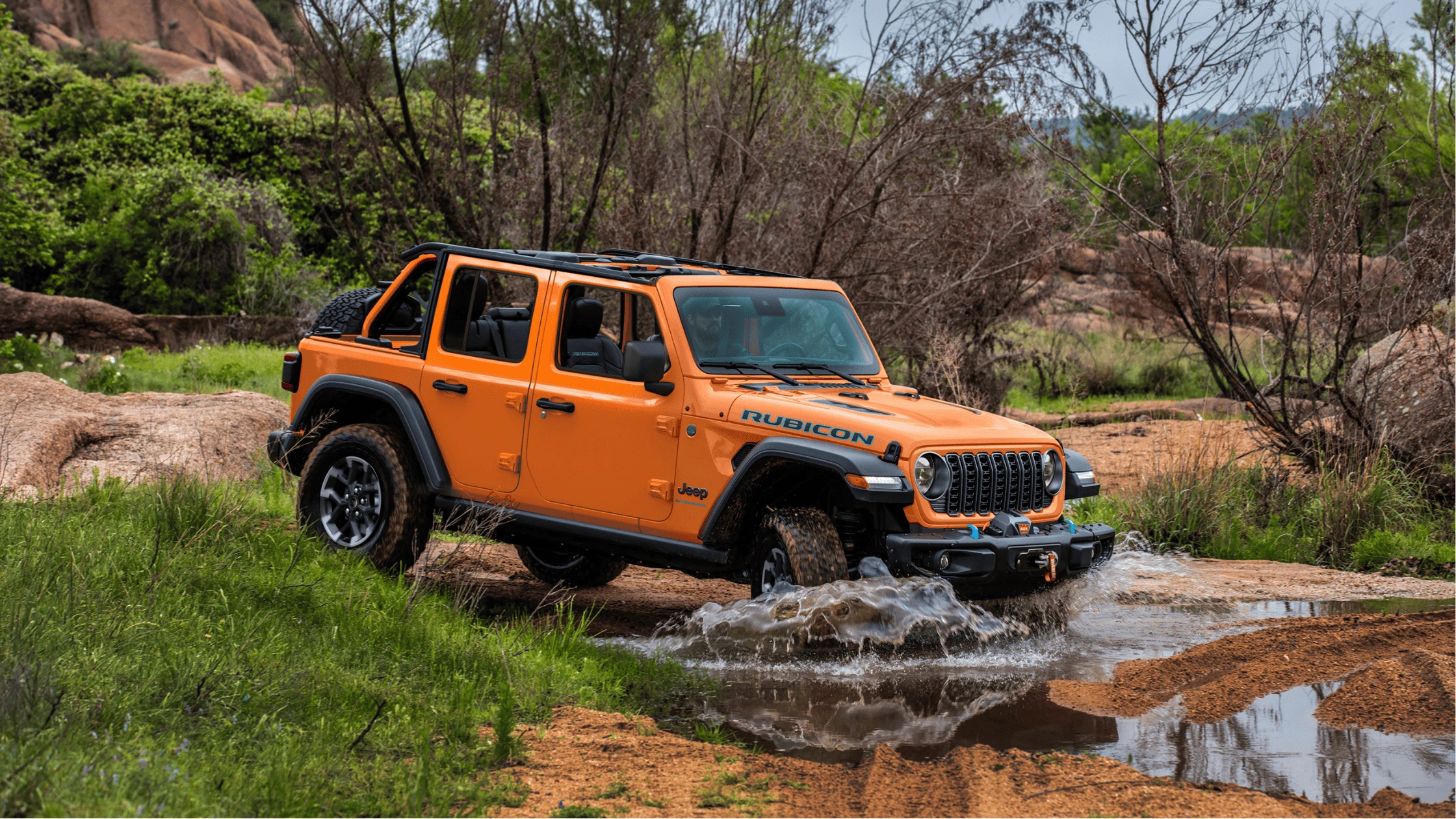 2025 Jeep® Gladiator Dark Sky parked near a wooded trail in Cape Coral, showing off its rugged night-ready design.