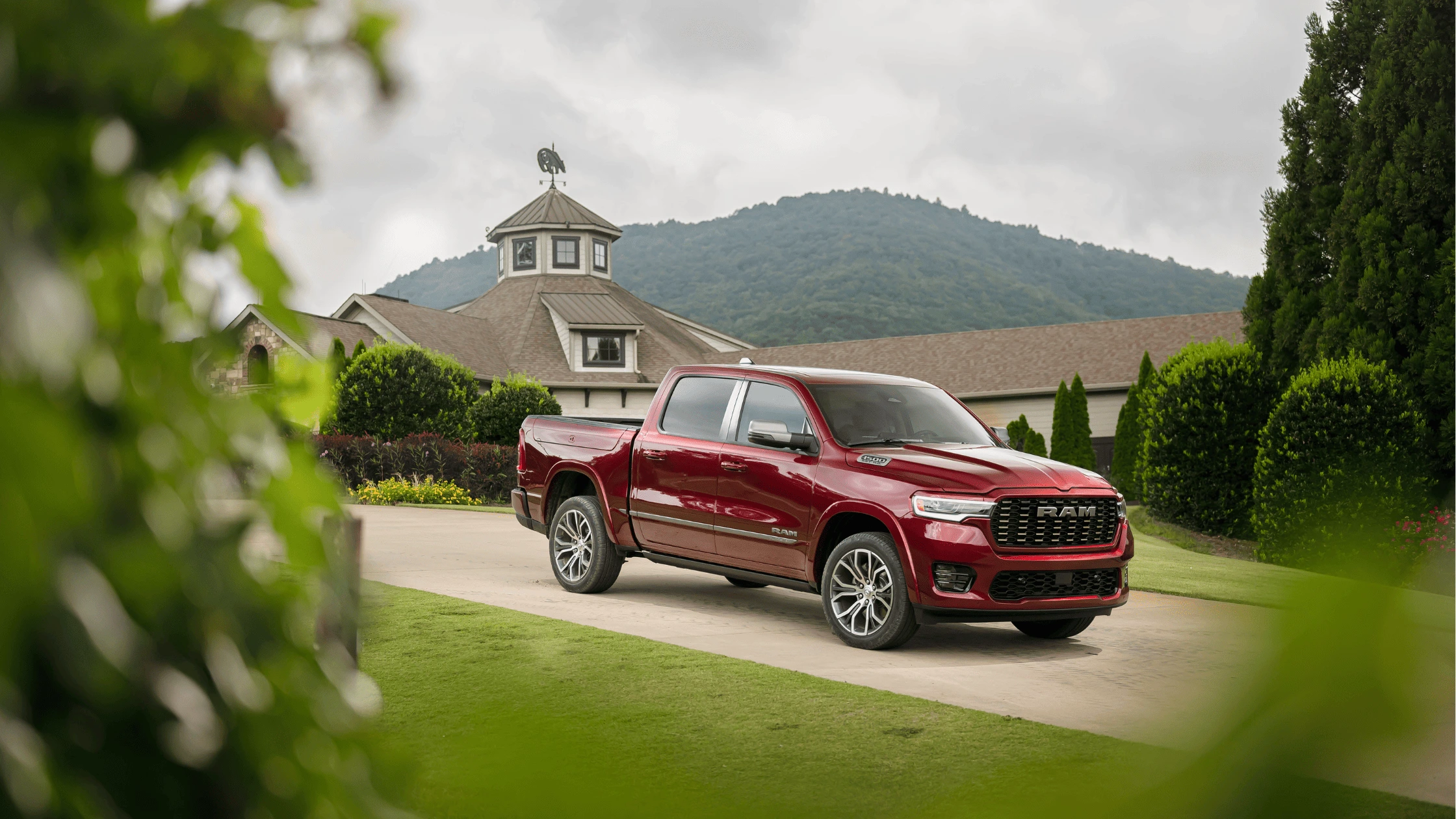 2025 Ram 1500 parked in front of a countryside estate, showcasing its rugged design and premium styling for Fort Myers truck enthusiasts.