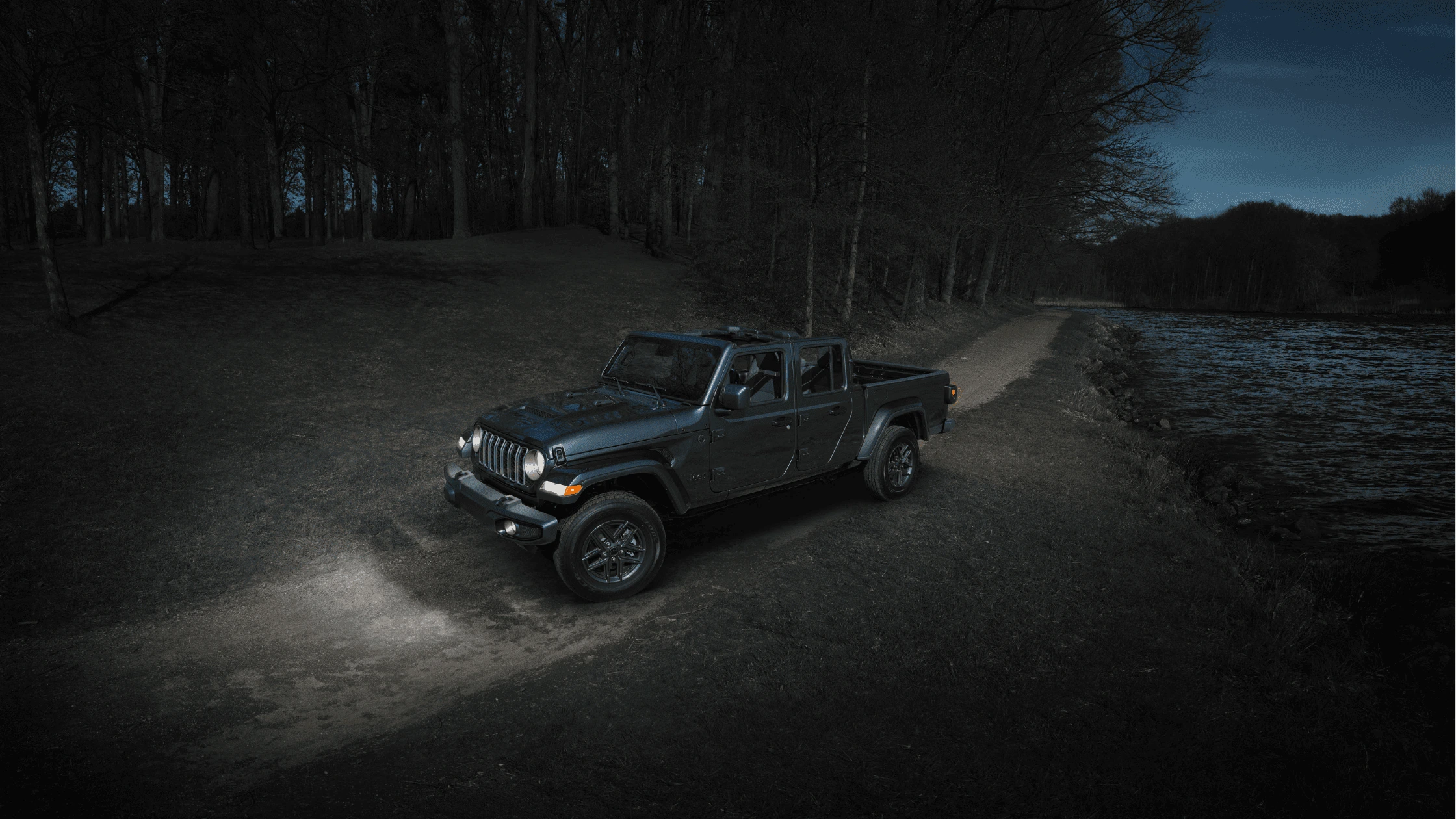 2025 Jeep Wrangler Rubicon in orange crossing muddy water near Cape Coral, built for off-road adventure.