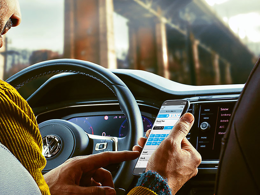 Person using a smartphone at the interior of a Volkswagen