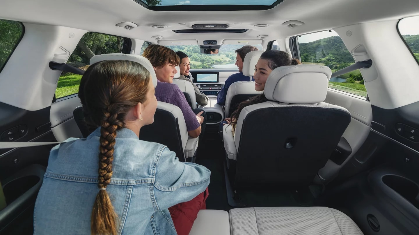 2027 Hyundai Palisade Hybrid, interior long view with a family