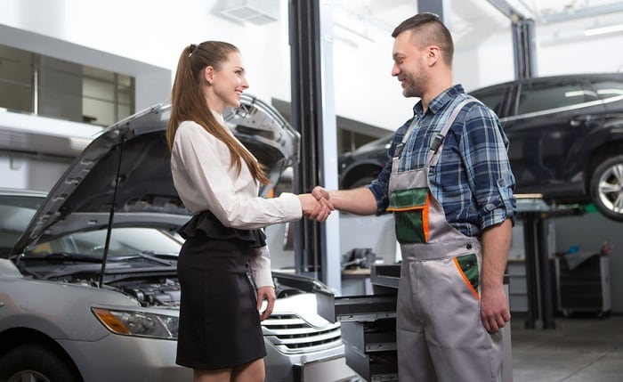 Mechanic and customer shaking hands