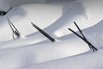 cars parked in snow with wipers sticking out