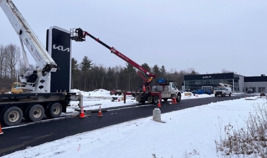 new Kia sign in front of new Garvey Kia building