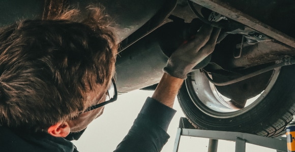 service technician inspecting vehicle