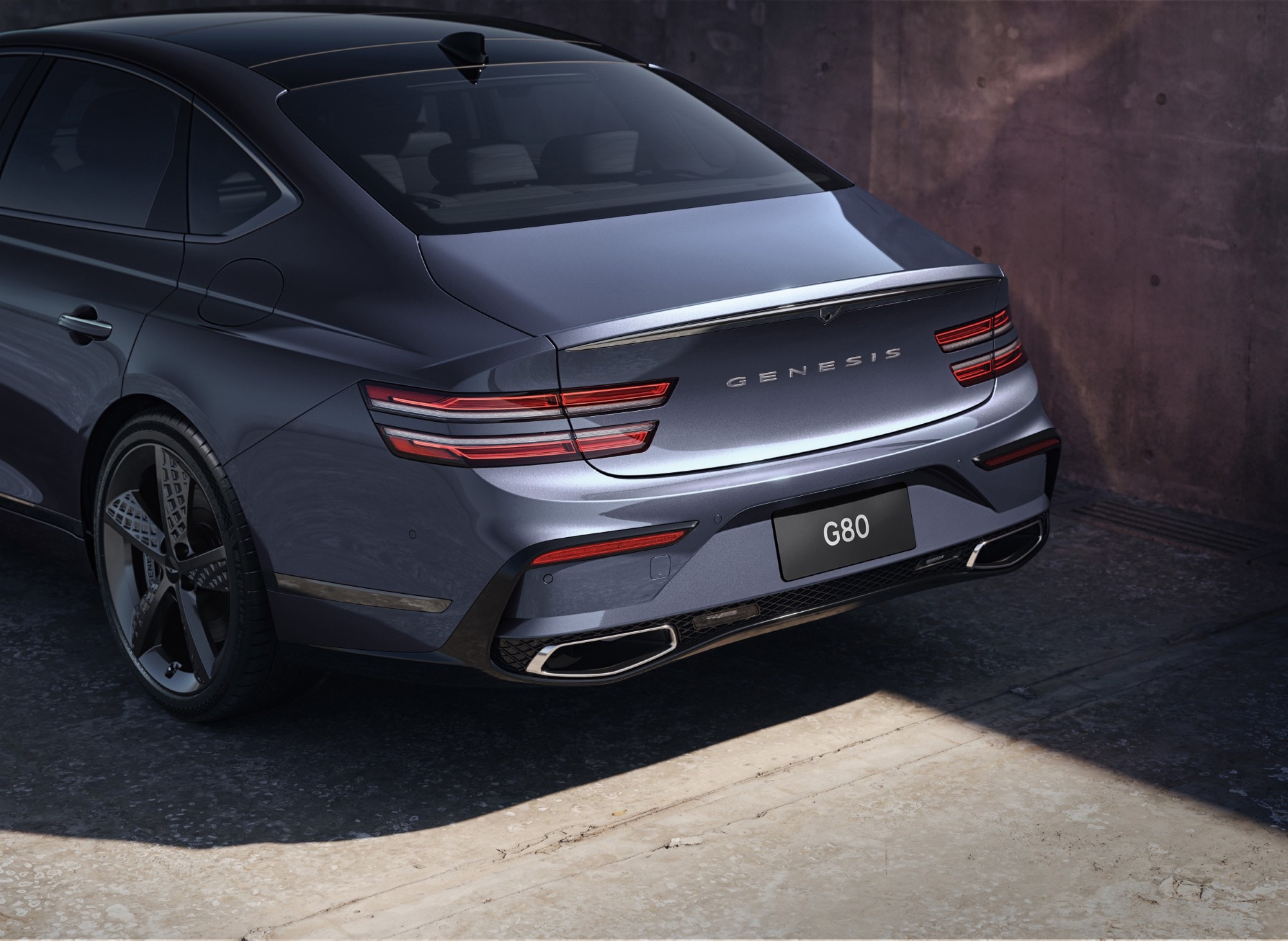3/4 rear driver side view of exterior, taillight and trunk detail on Genesis G80 in Ceres Blue
