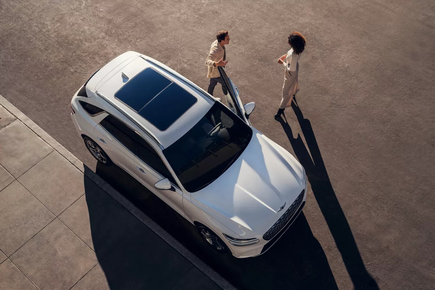 People meeting near Genesis vehicle