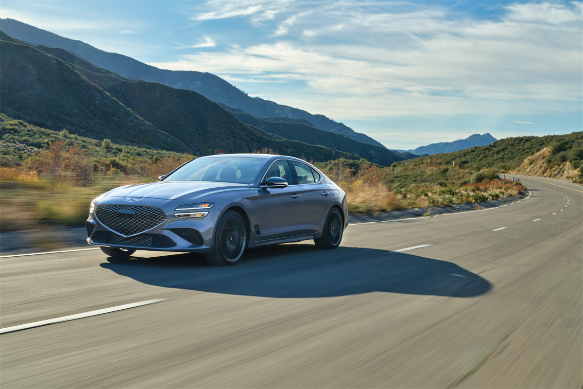 2026 Genesis G70 zooming down highway.