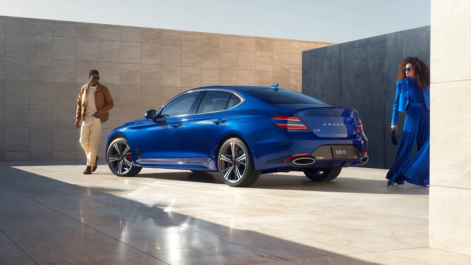 2026 Genesis G70 in blue finish, with two people