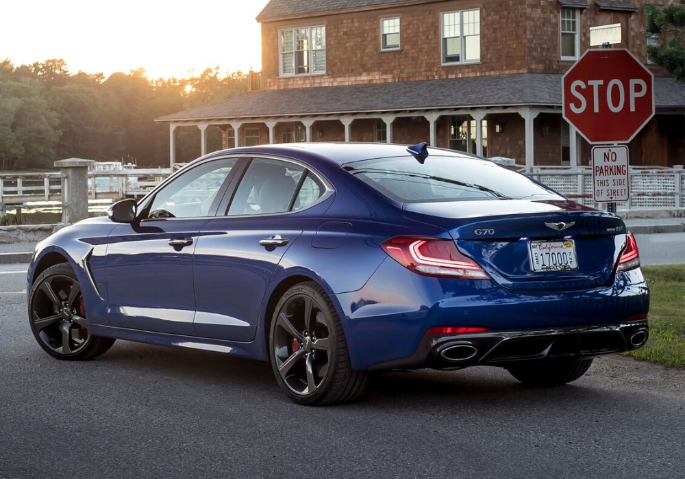 2020 Genesis G70 Exterior (1).png 2020 Genesis G70 luxury sedan rear exterior view coming to a stop sign at an intersection