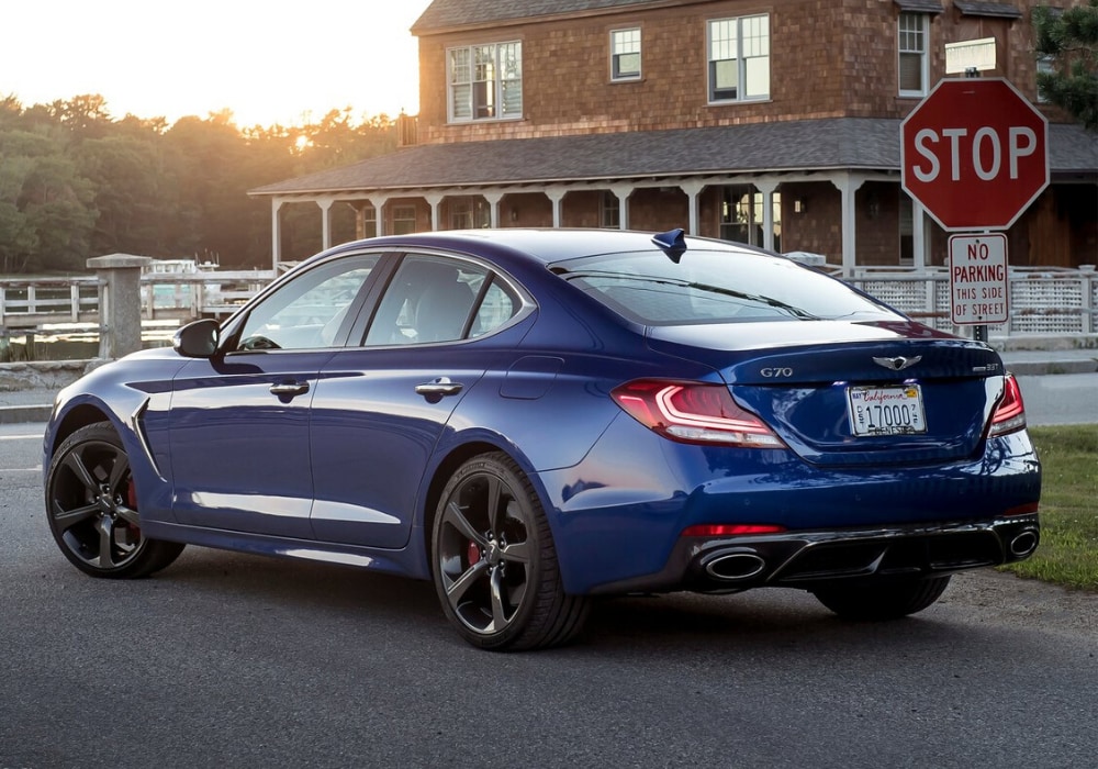 2020 Genesis G70 luxury sedan rear exterior view coming to a stop sign at an intersection