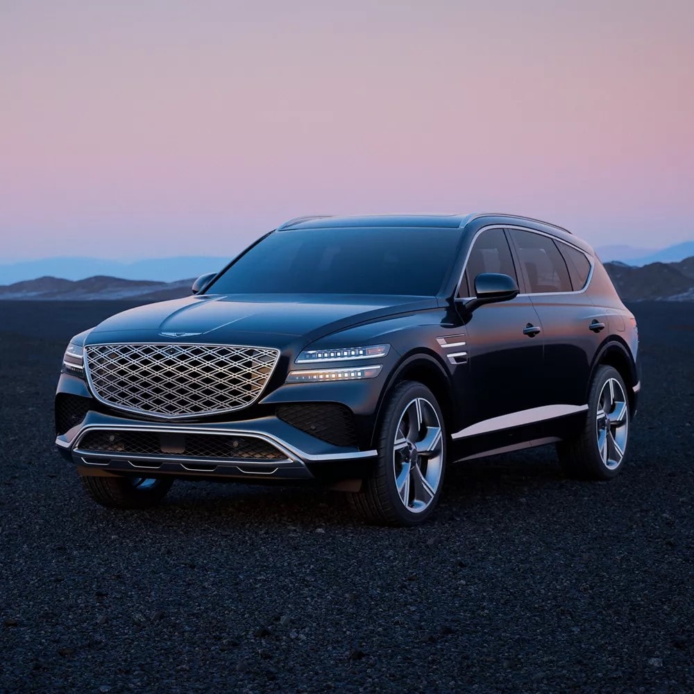 2025 Genesis GV80 parked on a rocky beach