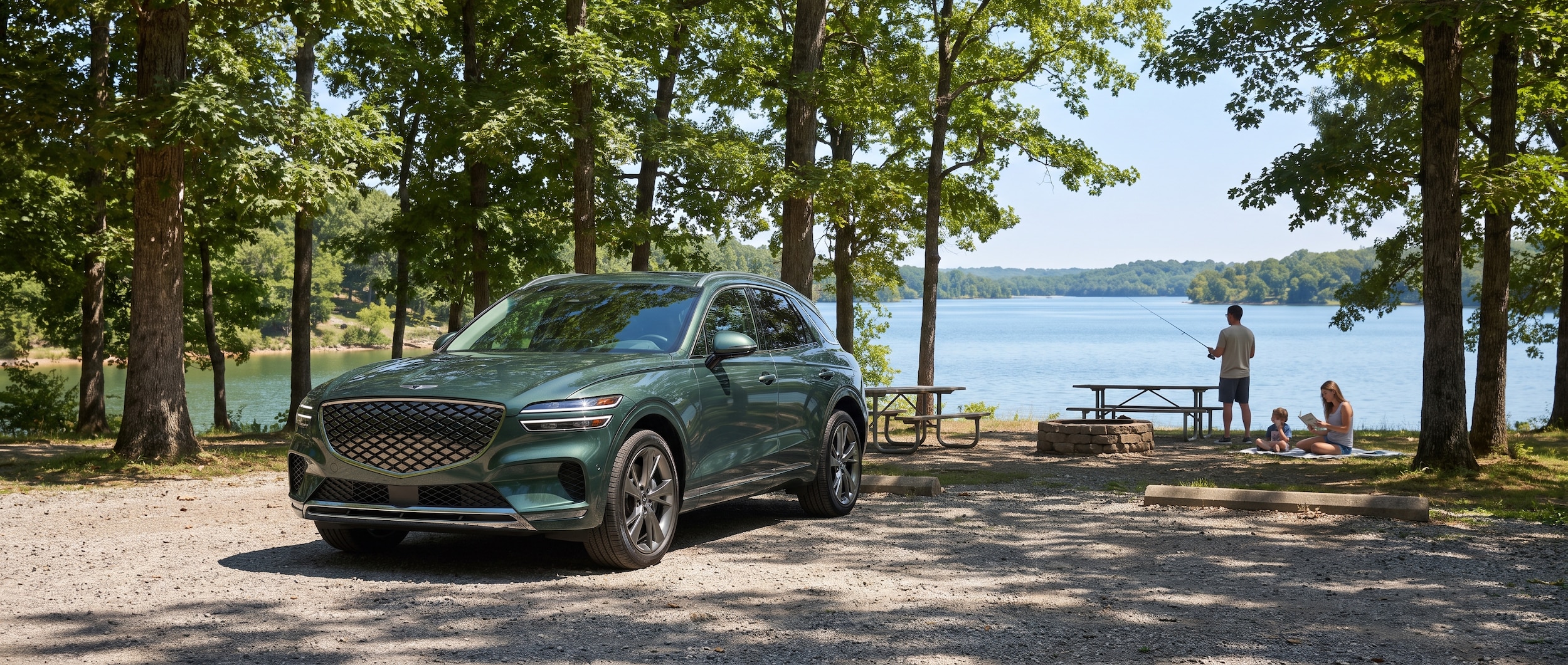 A 2026 Genesis GV70 in a deep blue or green exterior parked at a lakeside day-use area on a sunny summer day, surrounded by tall Tennessee hardwoods, with the calm blue water of Percy Priest Lake visible in the background