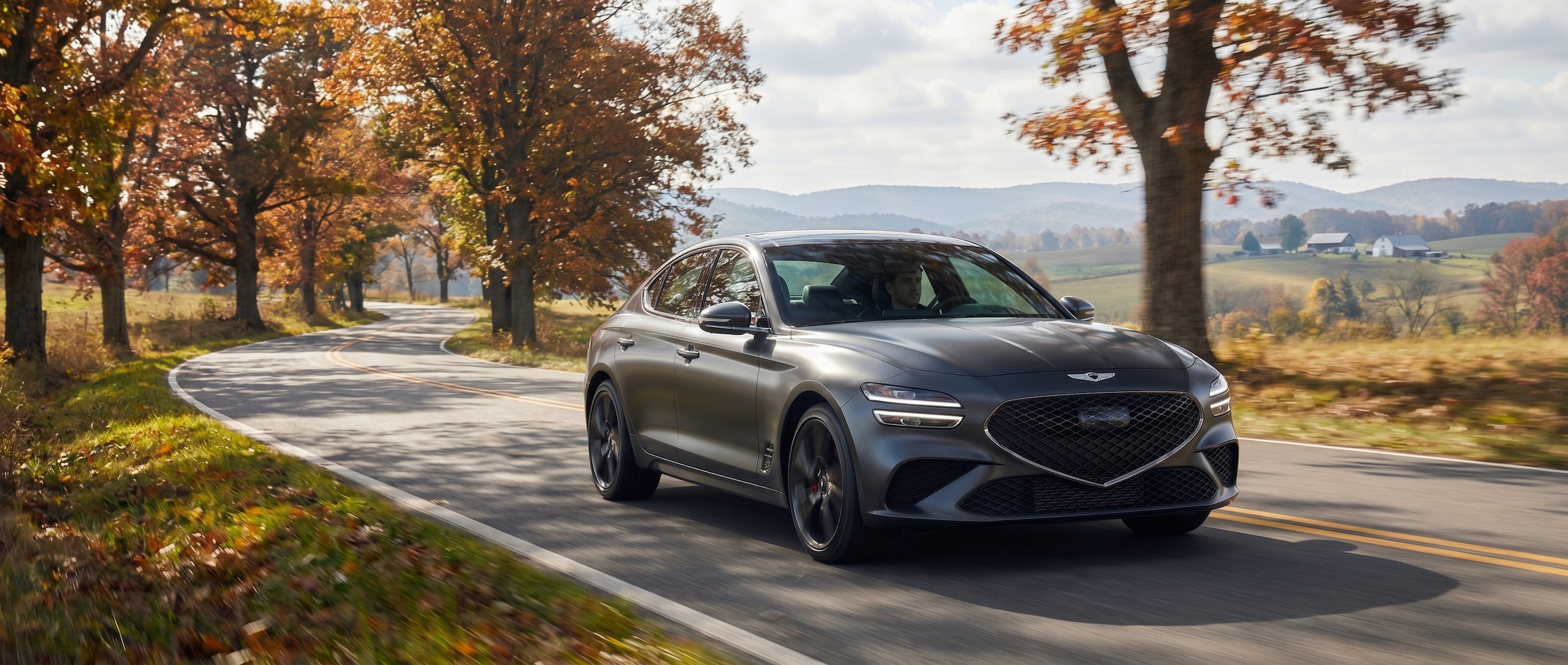 Genesis G70 driving on scenic roads near Percy Warner Park Nashville TN