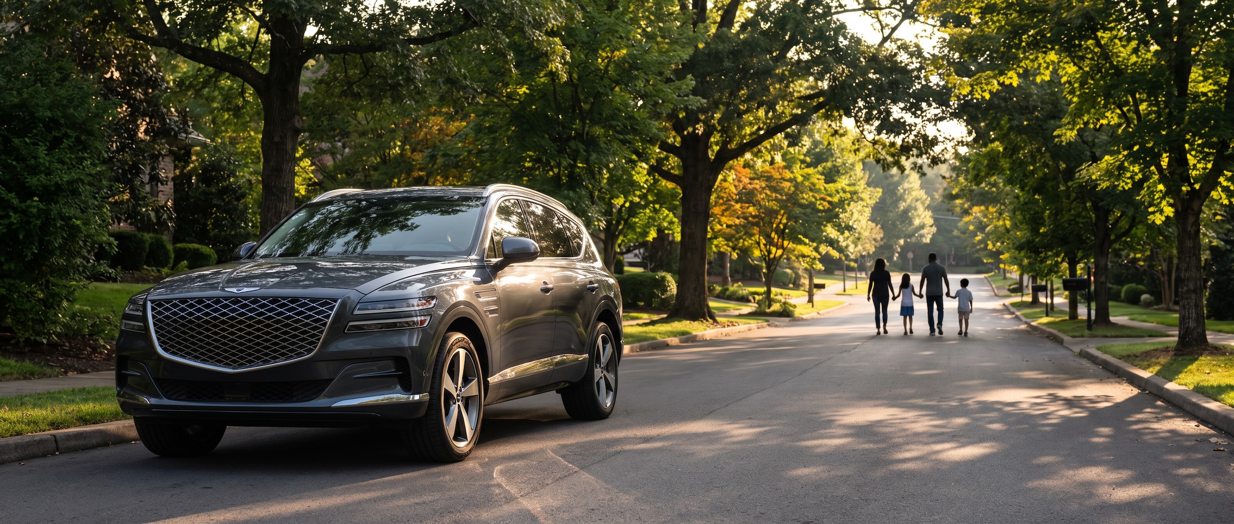 2026 Genesis GV80 in Makalu Gray parked in a leafy Brentwood, TN residential neighborhood on a late-summer afternoon, rear liftgate open showing the cargo area with a stroller and sports bag visible, family silhouette in background
