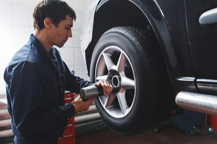 Technician installing new Genesis tires