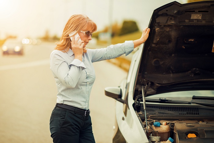 Woman calling Genesis Roadside Assistance