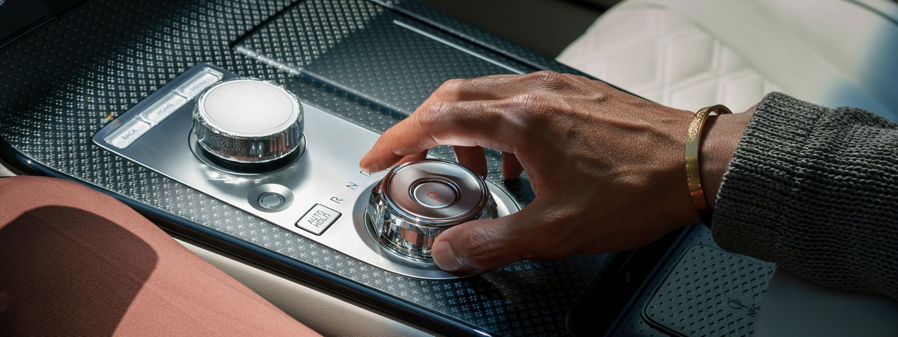Driver adjusting the gear selector in the 2027 Genesis G80