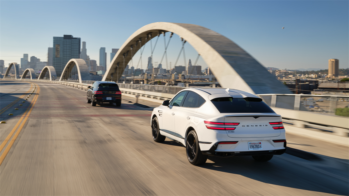 The 2026 Genesis GV80 Coupe driving on a bridge
