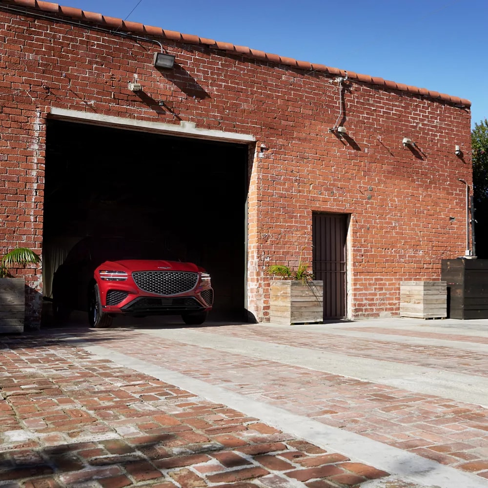 A Genesis Certified Pre-Owned vehicle sitting in a garage